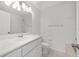 Bright bathroom with a single vanity, toilet, tiled floors, and a walk-in shower at 2899 Sw 66 St, Ocala, FL 34476