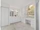 The bathroom features a double sink vanity, tiled floor, and large window at 2899 Sw 66 St, Ocala, FL 34476