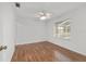 Bright bedroom with hardwood floors, ceiling fan, and large window allowing for ample natural light at 2899 Sw 66 St, Ocala, FL 34476
