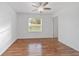 Bedroom featuring hardwood floors, white walls, a ceiling fan, and ample natural light at 2899 Sw 66 St, Ocala, FL 34476