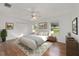 Stylishly furnished bedroom with light wood floors, a ceiling fan, and natural light at 2899 Sw 66 St, Ocala, FL 34476