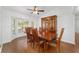 Bright dining room featuring a wood table, chairs, hardwood floors, and a large window at 2899 Sw 66 St, Ocala, FL 34476