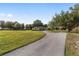 Inviting single-story home featuring a circular driveway and lush, green lawn at 2899 Sw 66 St, Ocala, FL 34476