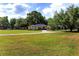 Charming single-story house surrounded by a wide green lawn and mature trees at 2899 Sw 66 St, Ocala, FL 34476