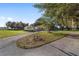 Inviting single-story home featuring a circular driveway, lush landscaping, and mature trees at 2899 Sw 66 St, Ocala, FL 34476