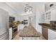 Modern kitchen with stainless steel appliances, white cabinetry, and granite countertops at 2899 Sw 66 St, Ocala, FL 34476