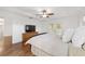 Bright main bedroom features wood floors, tray ceiling with fan, and access to the pool at 2899 Sw 66 St, Ocala, FL 34476