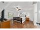 Bright main bedroom with hardwood floors, a ceiling fan, and french doors leading to the backyard at 2899 Sw 66 St, Ocala, FL 34476