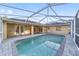 Enjoy the view of this screened-in pool area featuring brick pavers and beautiful backyard at 2899 Sw 66 St, Ocala, FL 34476
