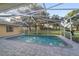 Gorgeous screened-in pool with brick pavers overlooking the lush green yard at 2899 Sw 66 St, Ocala, FL 34476