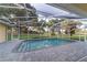 Relaxing screened-in pool features brick pavers, lush greenery, and offers outdoor enjoyment at 2899 Sw 66 St, Ocala, FL 34476