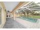 Enjoy outdoor living with this screened-in pool, brick pavers, and a spacious covered patio at 2899 Sw 66 St, Ocala, FL 34476