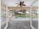Inviting screened-in pool area with ceiling fan, brick pavers, and views of the backyard at 2899 Sw 66 St, Ocala, FL 34476