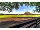 Green acreage on an equestrian estate behind a dark wooden fence at 2899 Sw 66 St, Ocala, FL 34476