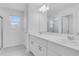 Bright bathroom showcasing double sinks with modern faucets and shower behind a glass enclosure at 5133 Forget Me Not Ave, Lake Hamilton, FL 33851