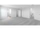 Bright bedroom showcasing neutral carpet and multiple doorways, including a door to the walk-in closet at 5133 Forget Me Not Ave, Lake Hamilton, FL 33851