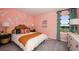Vibrant bedroom with pink walls, butterfly accents, and coordinated decor offering a playful and inviting space at 5133 Forget Me Not Ave, Lake Hamilton, FL 33851