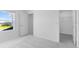 Bright bedroom showcasing neutral carpet, a window overlooking neighborhood homes, and a door to the closet at 5133 Forget Me Not Ave, Lake Hamilton, FL 33851