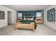 Primary bedroom with a teal accent wall, decorative pillows, wood nightstands and modern art pieces at 5133 Forget Me Not Ave, Lake Hamilton, FL 33851