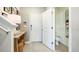 Bright entryway with a white door, neutral walls, modern console table and convenient half bathroom at 5133 Forget Me Not Ave, Lake Hamilton, FL 33851