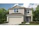 Charming two-story home featuring a 2-car garage, neutral siding, complemented by lush landscaping and a well-maintained lawn at 5133 Forget Me Not Ave, Lake Hamilton, FL 33851