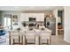 Bright kitchen with white cabinets, stainless steel appliances, large island and modern barstools at 5133 Forget Me Not Ave, Lake Hamilton, FL 33851