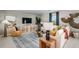 Modern living room with neutral tones, stylish furniture, a flat-screen TV and ample natural light at 5133 Forget Me Not Ave, Lake Hamilton, FL 33851