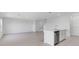 Bright living room highlighting an open floor plan that showcases a view of the kitchen's island sink and modern finishes at 5133 Forget Me Not Ave, Lake Hamilton, FL 33851