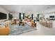 Spacious living room featuring tile flooring, a comfortable sectional sofa, and an open layout connected to the kitchen at 5133 Forget Me Not Ave, Lake Hamilton, FL 33851