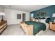 Stylish main bedroom with a blue accent wall, neutral carpet, and tasteful decor creating a serene retreat at 5133 Forget Me Not Ave, Lake Hamilton, FL 33851