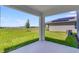 A covered outdoor patio overlooks a large grassy area at 5133 Forget Me Not Ave, Lake Hamilton, FL 33851
