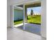 A view from inside of sliding glass doors opening to a patio and green lawn extending to other homes in the community at 5133 Forget Me Not Ave, Lake Hamilton, FL 33851