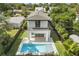 Aerial view of backyard featuring a pool and outdoor living space with a patio balcony above at 1521 Chestnut Ave, Winter Park, FL 32789