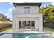 Back of modern home with a pool and views into the interior of the home at 1521 Chestnut Ave, Winter Park, FL 32789