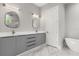 Stylish bathroom featuring double vanity, elegant mirrors, modern fixtures, and a luxurious soaking tub at 1521 Chestnut Ave, Winter Park, FL 32789