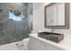 Modern bathroom featuring an attractive stone sink, sleek gray vanity, and glass-enclosed shower with gray tile at 1521 Chestnut Ave, Winter Park, FL 32789