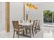 Modern dining room with a large table, comfortable seating, and a view of the outdoor pool at 1521 Chestnut Ave, Winter Park, FL 32789