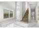 Grand foyer showcasing a staircase, high ceilings, marble floors, natural light, and an elegant entrance at 1521 Chestnut Ave, Winter Park, FL 32789