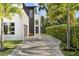 Two-story home with long driveway lined with palm trees, garage, and dark front door at 1521 Chestnut Ave, Winter Park, FL 32789