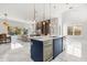Open-concept kitchen with large island, modern lighting, and seamless flow into the living area at 1521 Chestnut Ave, Winter Park, FL 32789