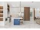 Bright kitchen with white cabinets, a blue island, and stainless steel appliances at 1521 Chestnut Ave, Winter Park, FL 32789
