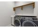 Convenient laundry room with modern washer and dryer, built-in sink, and ample storage space at 1521 Chestnut Ave, Winter Park, FL 32789