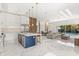 Spacious open-concept kitchen and living area with island, modern furniture, and access to the backyard pool at 1521 Chestnut Ave, Winter Park, FL 32789