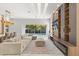 Spacious living area with sectional sofa, large windows, and a view of the pool area at 1521 Chestnut Ave, Winter Park, FL 32789