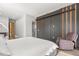 Bright main bedroom featuring wood floors, chair, and a stylish wardrobe with lighting accents at 1521 Chestnut Ave, Winter Park, FL 32789