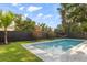 Tranquil pool area with a refreshing pool, well-manicured lawn, privacy fencing, and beautiful tropical trees at 1521 Chestnut Ave, Winter Park, FL 32789