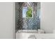 Modern shower with blue and gray accent tiles and frameless glass door at 1521 Chestnut Ave, Winter Park, FL 32789