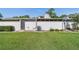 The backyard features a well-maintained lawn, privacy fence, and air conditioning unit at 2049 Se 37Th Court Cir, Ocala, FL 34471