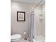 Clean bathroom featuring a shower, toilet, and decorative accents at 2049 Se 37Th Court Cir, Ocala, FL 34471