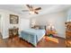 Cozy bedroom showcasing a ceiling fan, wood floors, and a full size bed at 2049 Se 37Th Court Cir, Ocala, FL 34471